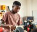 A Ghanaian student working on a robotics and STEM projects in a classroom.